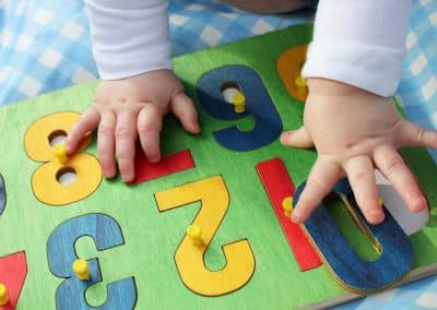 baby playing with a numbers puzzle