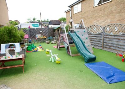 Clarence House Chatteris Nursery garden with climbing frame and slide and other outside toys