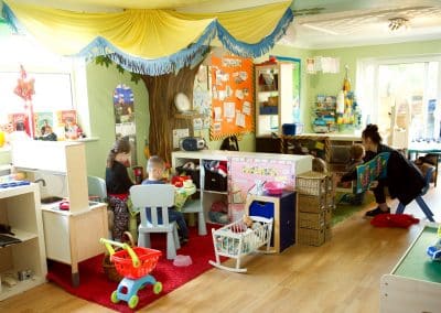 Clarence House Chatteris Nursery, preschool room with several children role playing