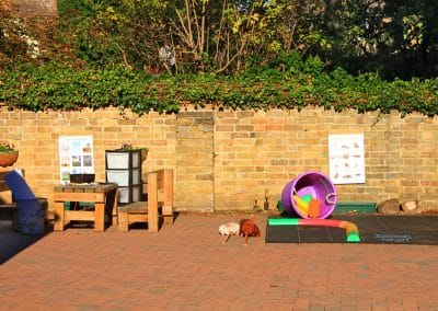 Garden space in Godmanchester preschool with a variety of outdoor toys and different play areas.