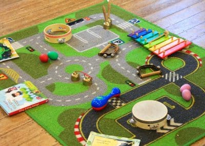 Children's musical instruments laid out on a road rug in Godmanchester preschool