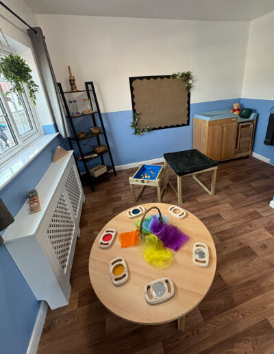 Tables set up for various activities in baby room at Clarence House Boston